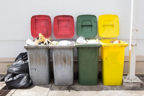 Workers loading commercial waste into a vehicle at a busy local site